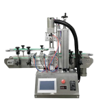 Compact tabletop bottle capping machine sealing round bottles with plastic caps on a conveyor belt