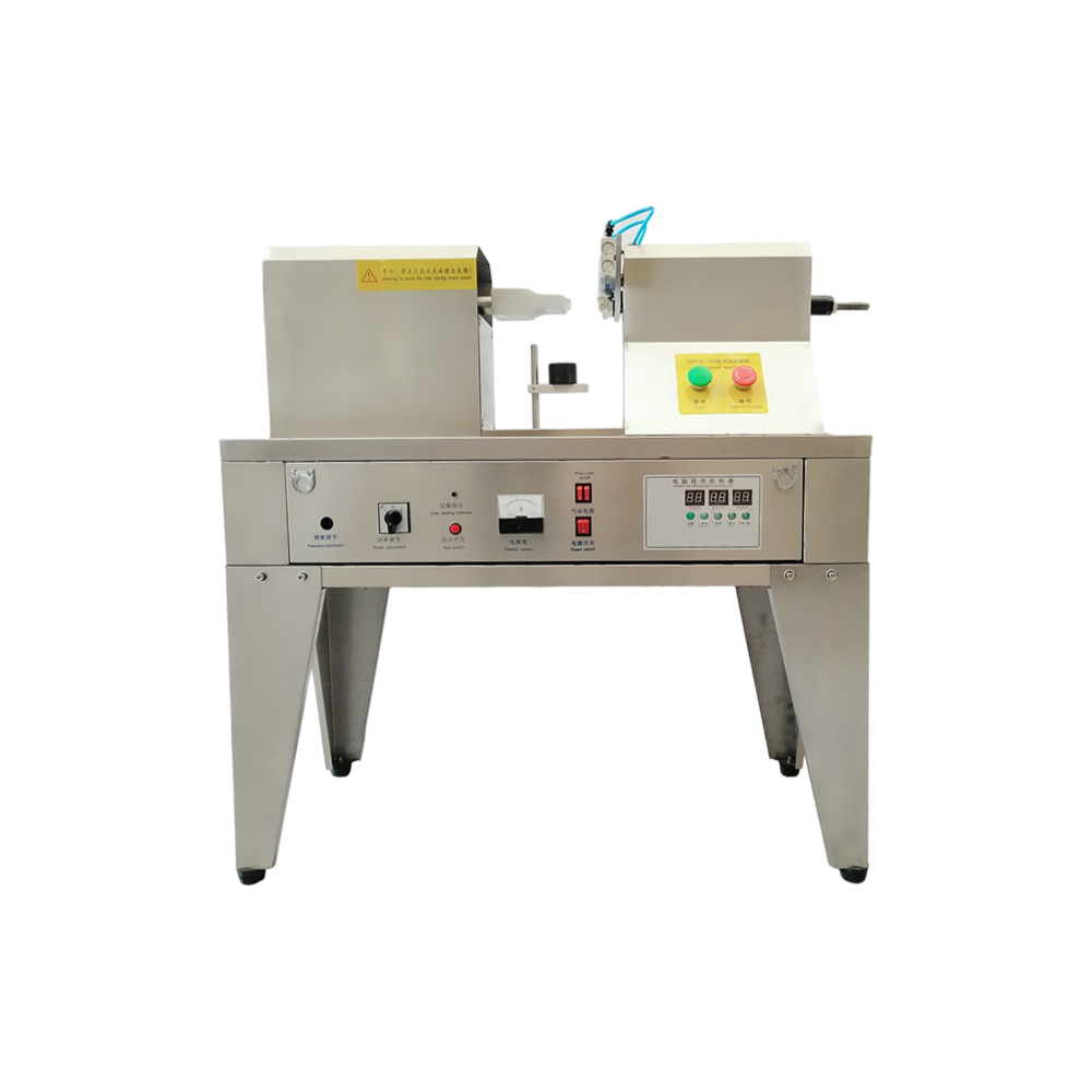 Ultrasonic tube sealing machine for plastic and aluminium tubes with adjustable worktable.
